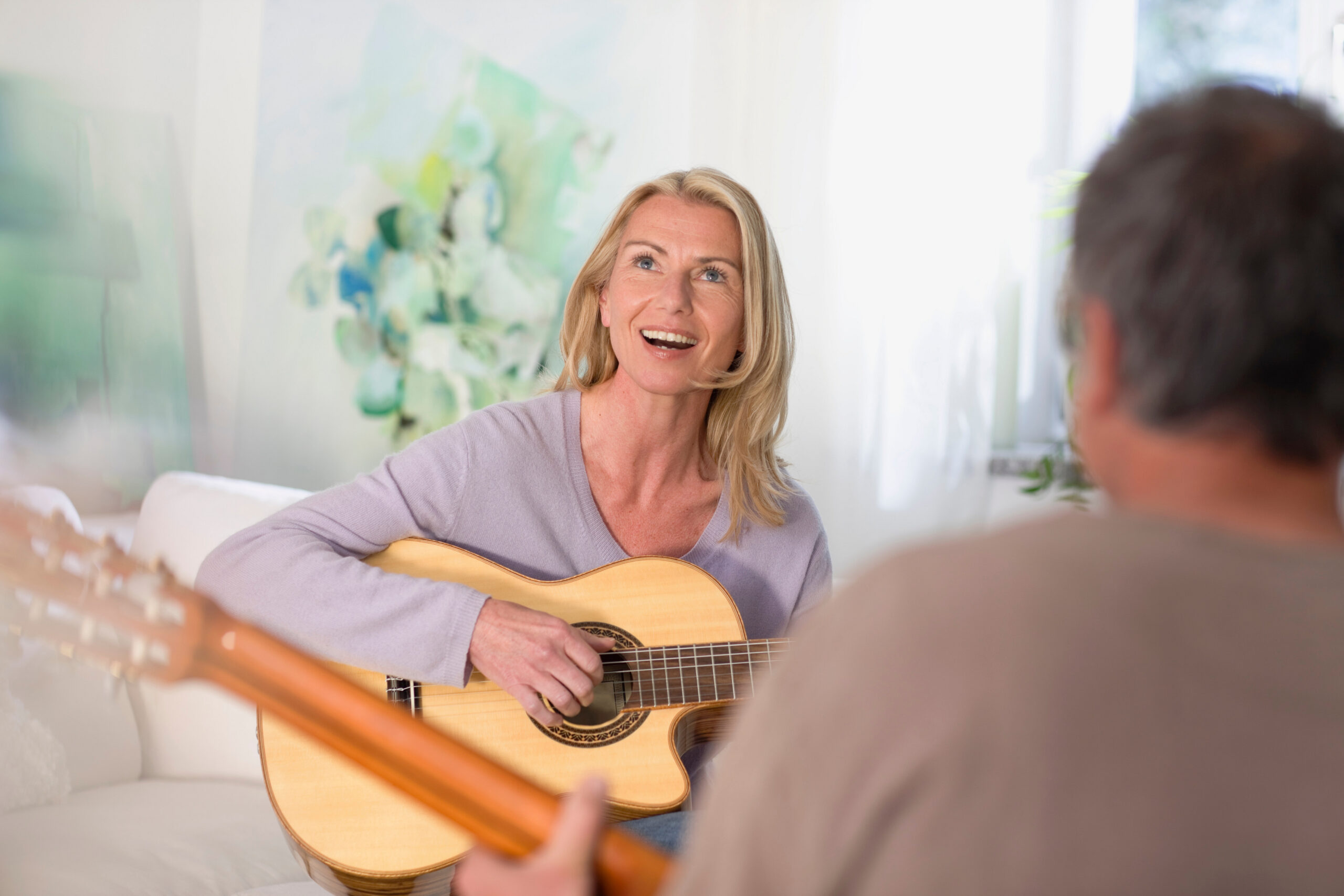 Middle Age woman in a guitar lesson