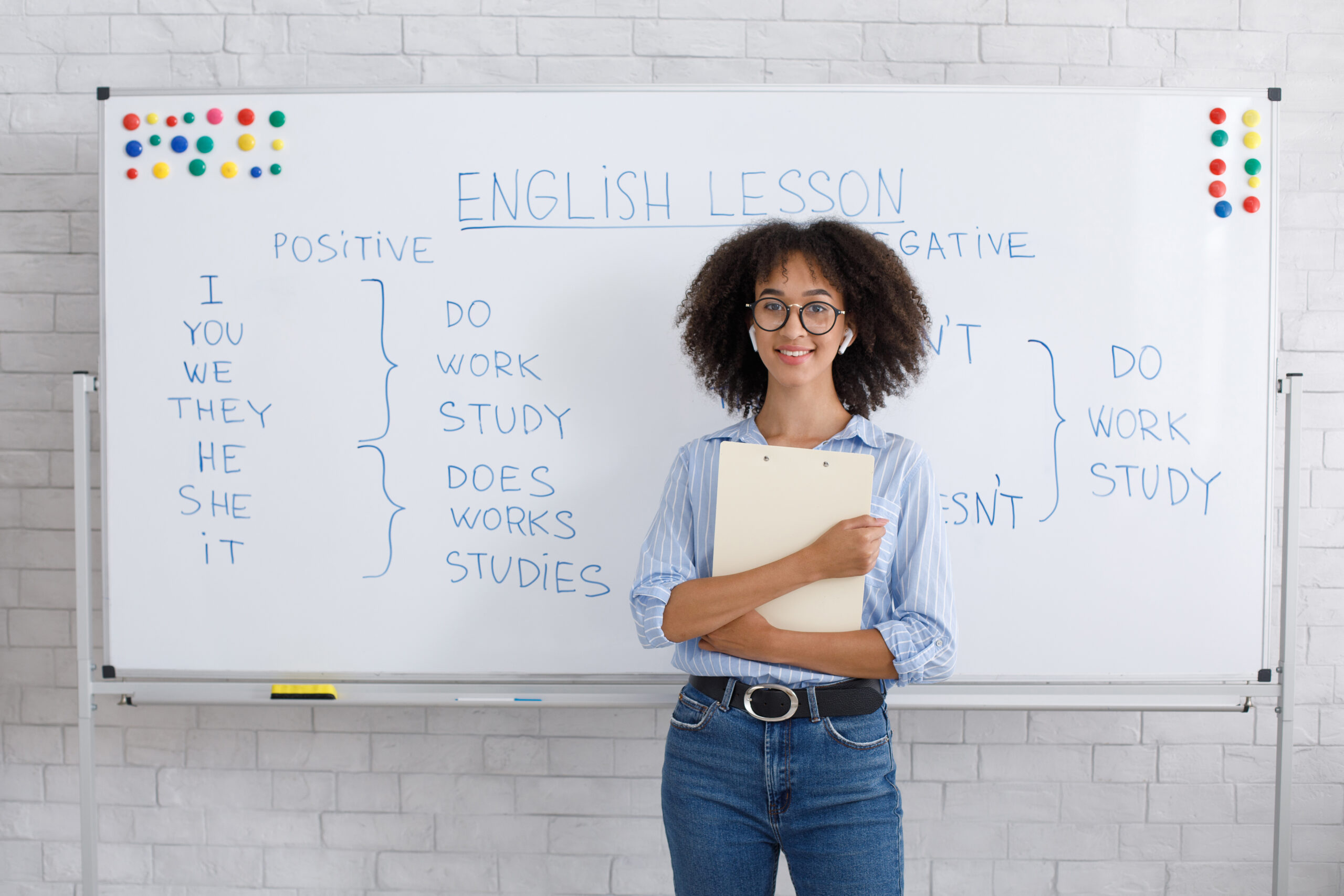 A woman giving an English lesson using a white board